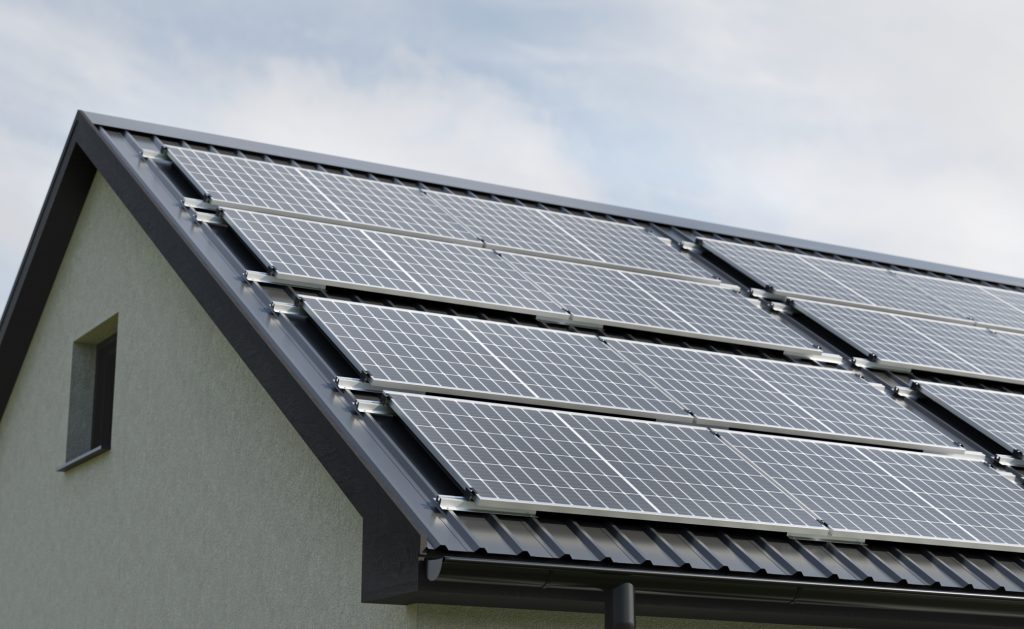Solar modules mounted on a pitched metal roof using REKOSOLAR rail and clamp system